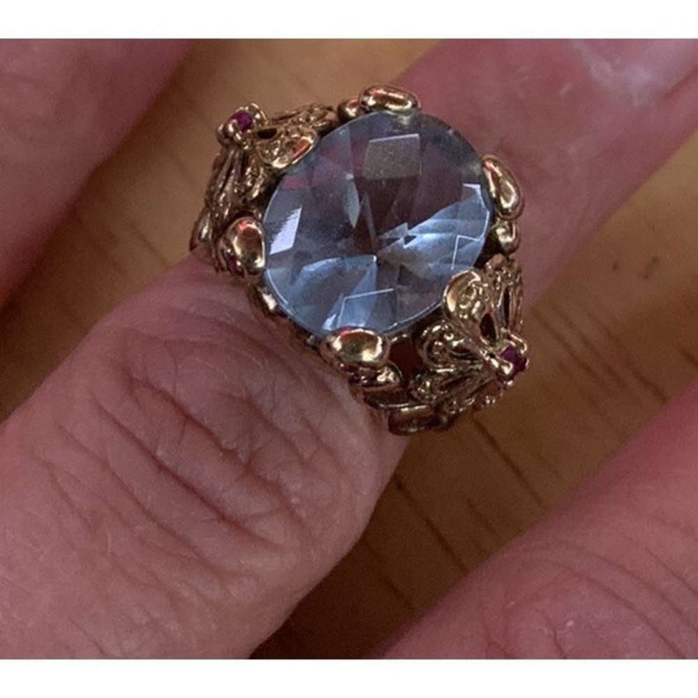silver and gold plated ring with one large blue stone and two Tiny  red stones